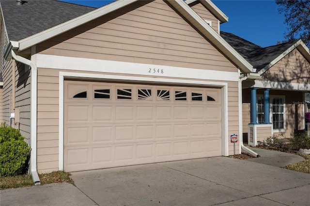 garage with concrete driveway