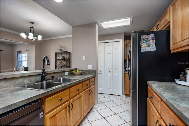 kitchen with light tile patterned floors, freestanding refrigerator, a sink, dishwasher, and dark countertops