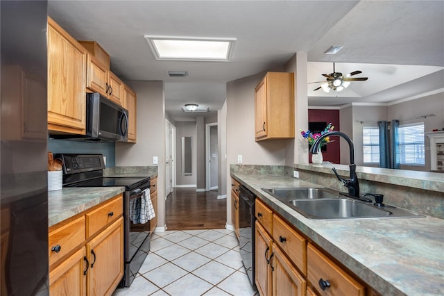 kitchen featuring visible vents, black appliances, a sink, light tile patterned floors, and ceiling fan