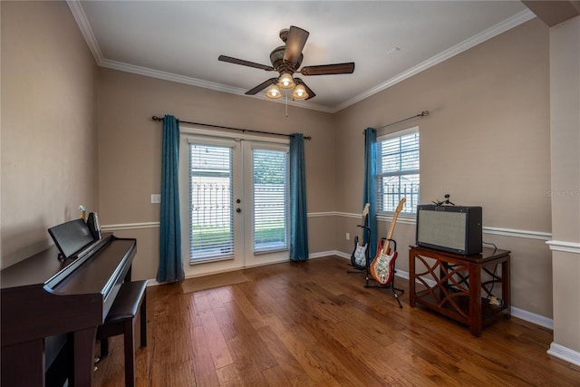 interior space with wood finished floors, baseboards, french doors, and ornamental molding