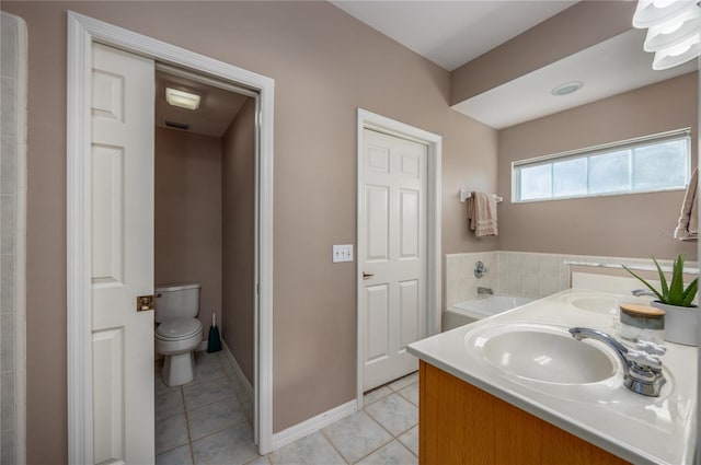 bathroom featuring tile patterned floors, toilet, baseboards, and a sink