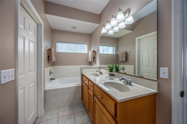 full bathroom featuring a sink, double vanity, a bath, and tile patterned floors