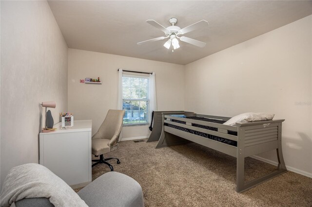 carpeted bedroom featuring baseboards and ceiling fan