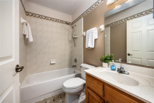 full bathroom featuring toilet, vanity, and  shower combination