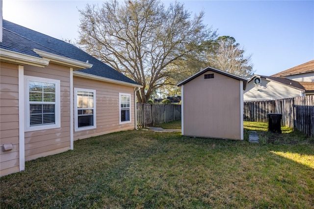 view of yard with a storage unit, a fenced backyard, and an outdoor structure