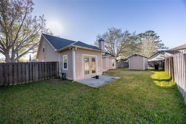 rear view of property featuring an outdoor structure, a fenced backyard, a chimney, and a shed