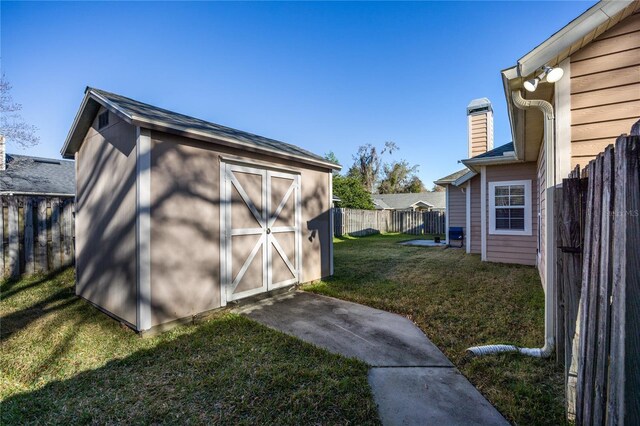 view of shed with a fenced backyard