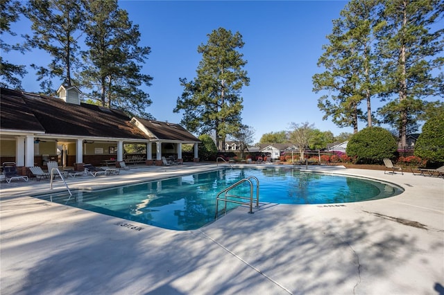 community pool featuring a patio and fence