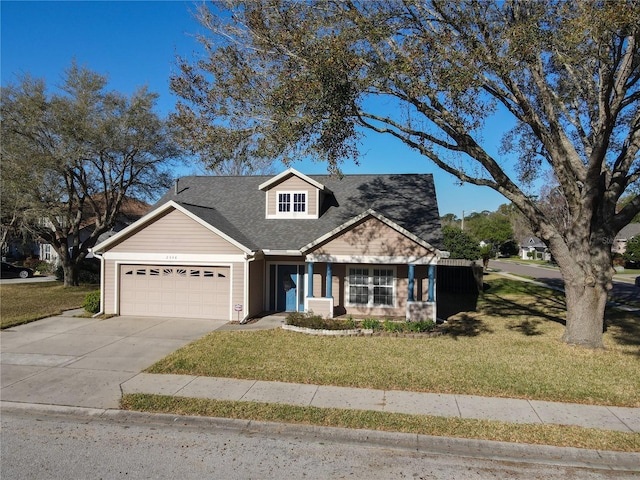 view of front of house with a front lawn, an attached garage, driveway, and roof with shingles