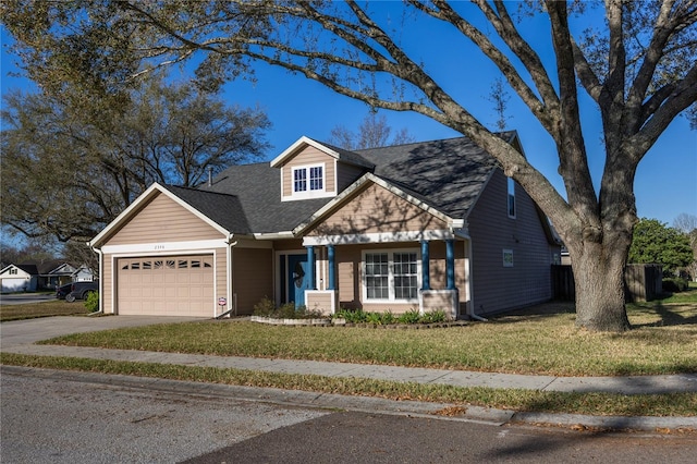 view of front facade with driveway, a front yard, a garage, and a shingled roof