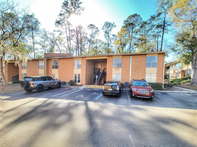 view of building exterior featuring uncovered parking