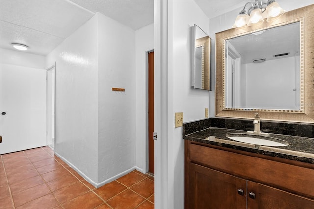 bathroom featuring baseboards, vanity, and tile patterned floors