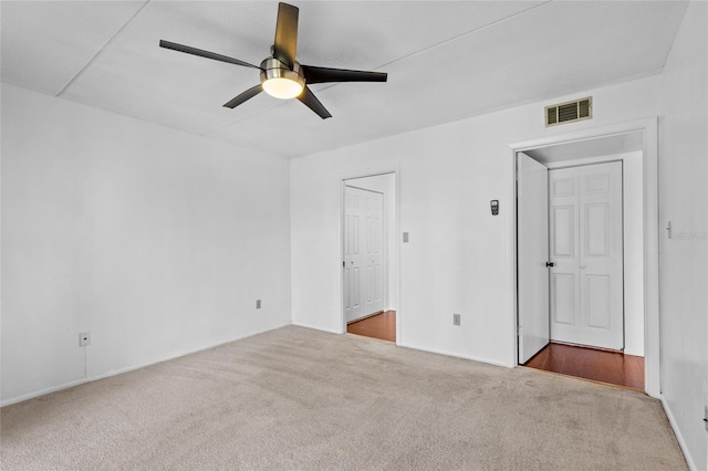 unfurnished bedroom featuring a ceiling fan, visible vents, and carpet flooring