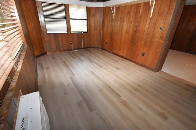 spare room with wooden walls and wood finished floors