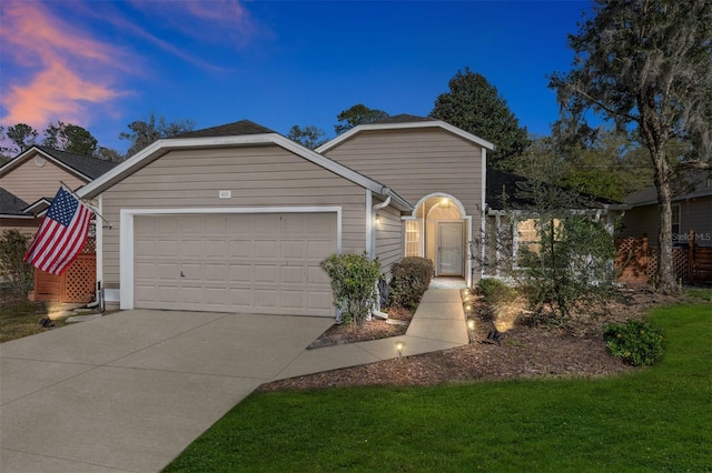 single story home with a garage and driveway