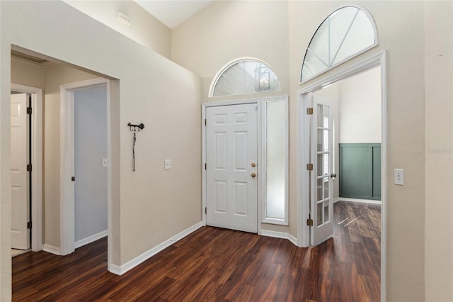 entryway featuring baseboards and dark wood-style flooring