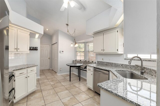 kitchen with dishwasher, lofted ceiling, a sink, double oven range, and backsplash