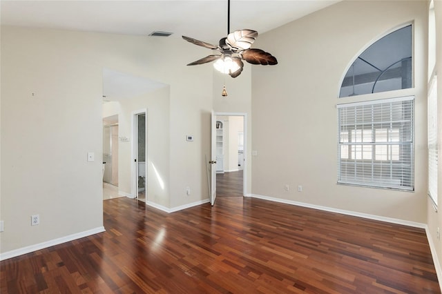 spare room featuring high vaulted ceiling, wood finished floors, a ceiling fan, visible vents, and baseboards