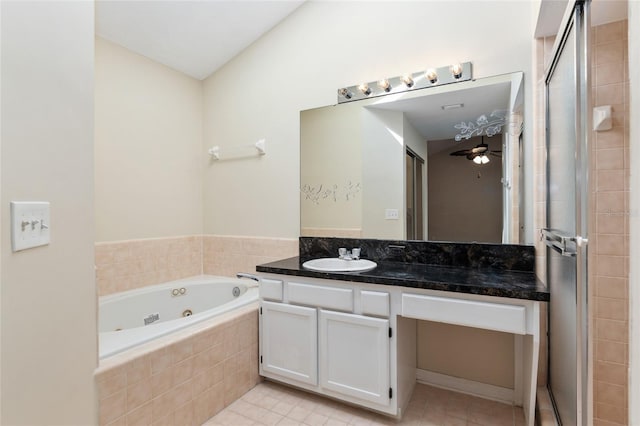 bathroom with a stall shower, vanity, a whirlpool tub, and tile patterned floors