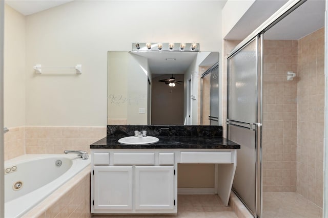 bathroom featuring a tub with jets, a stall shower, vanity, and a ceiling fan