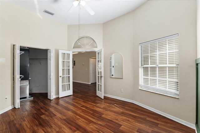 unfurnished bedroom with ceiling fan, wood finished floors, visible vents, baseboards, and french doors