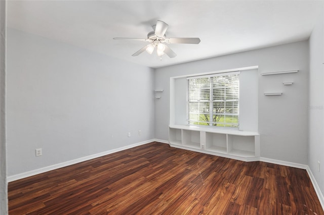 unfurnished room with ceiling fan, wood finished floors, and baseboards