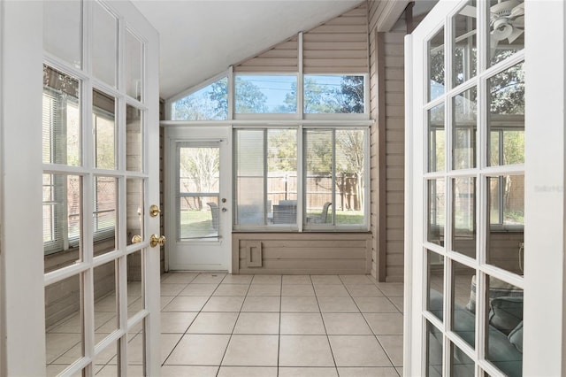 unfurnished sunroom featuring a healthy amount of sunlight and vaulted ceiling