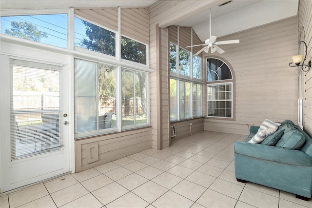 sunroom featuring a wealth of natural light, lofted ceiling, visible vents, and ceiling fan