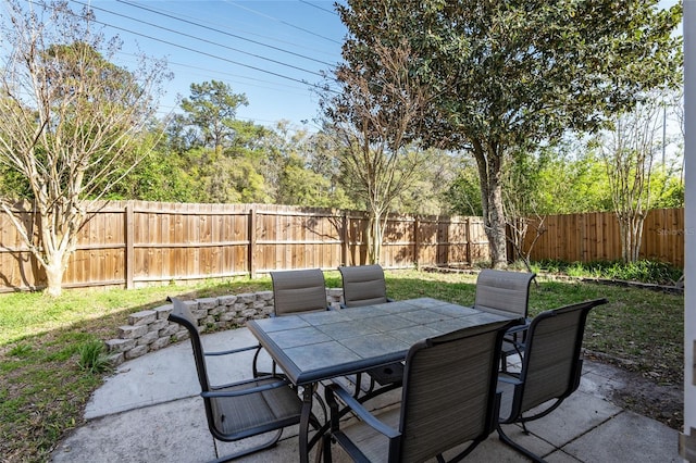 view of patio with outdoor dining area and a fenced backyard