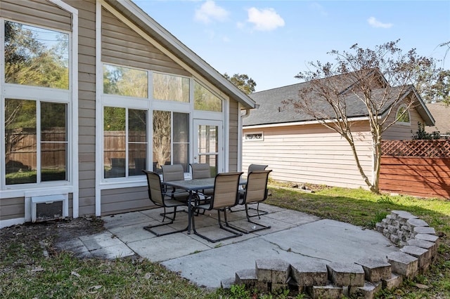 view of patio with a sunroom and fence