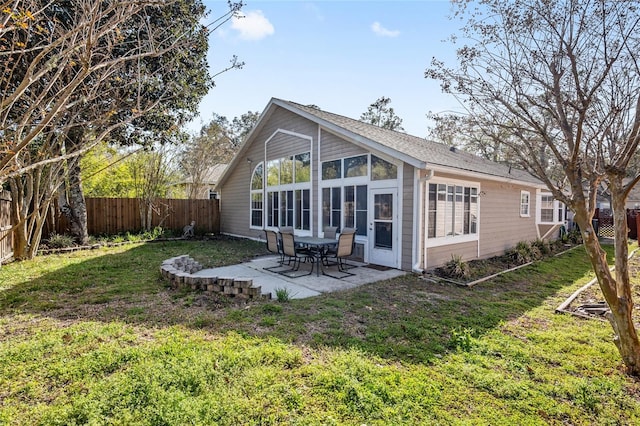 back of property featuring a patio area, a fenced backyard, and a lawn