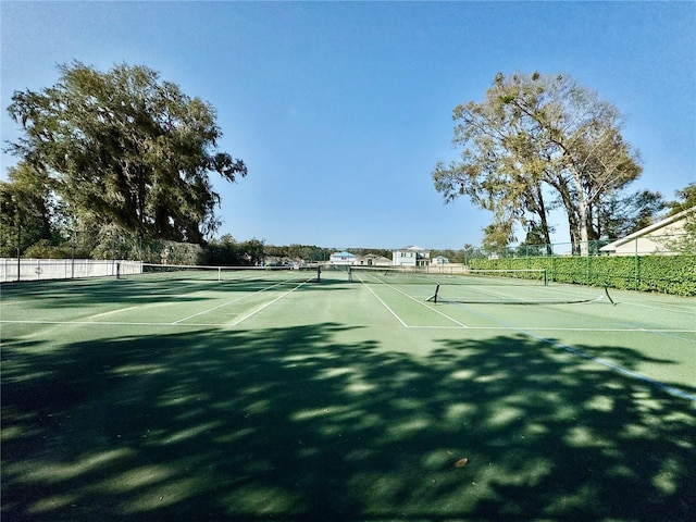 view of sport court featuring fence