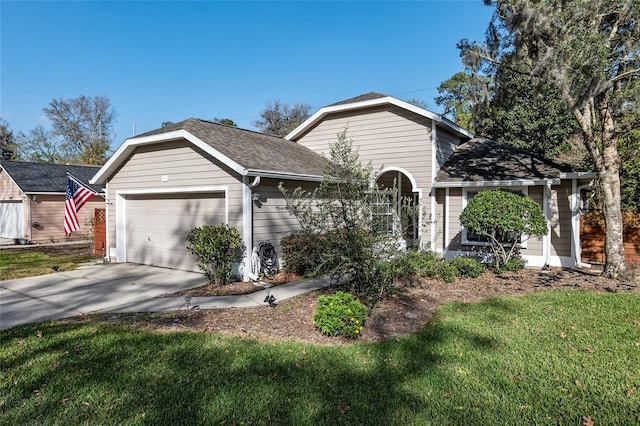 view of front facade featuring concrete driveway, a front lawn, roof with shingles, and an attached garage