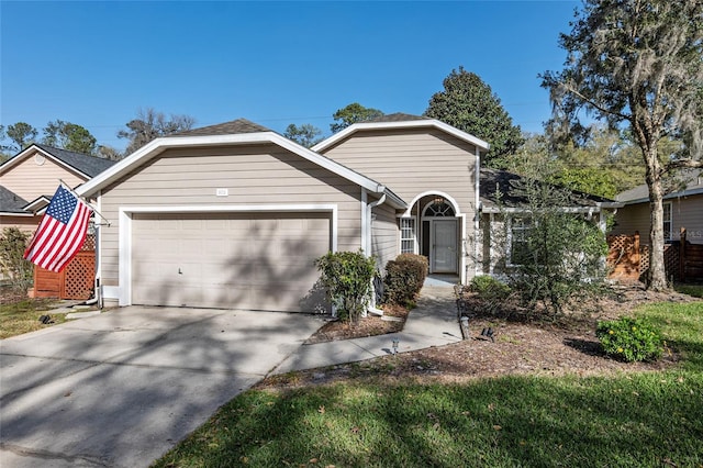 ranch-style house with concrete driveway and an attached garage