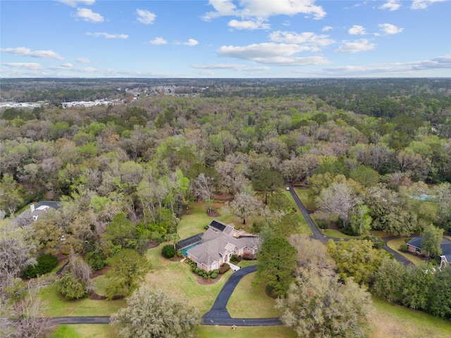 birds eye view of property featuring a view of trees