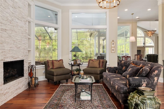 living area featuring dark wood finished floors, a fireplace, and ornamental molding