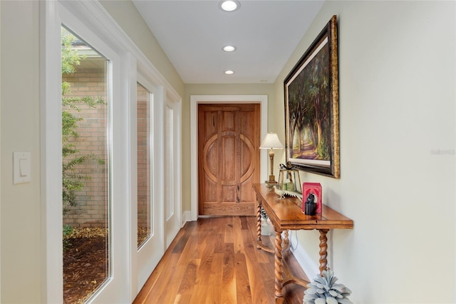 entryway with recessed lighting, baseboards, and light wood-style floors