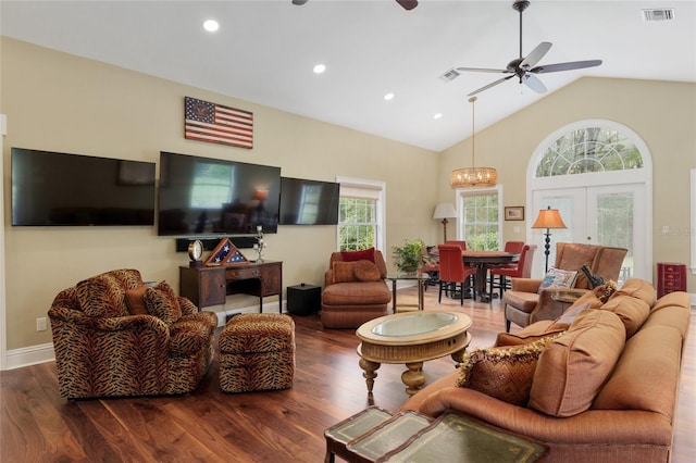 living area featuring visible vents, lofted ceiling, wood finished floors, and a ceiling fan