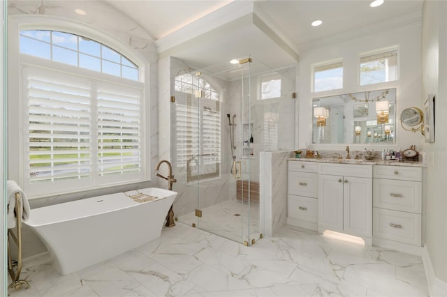 bathroom featuring vanity, a freestanding tub, ornamental molding, a shower stall, and marble finish floor