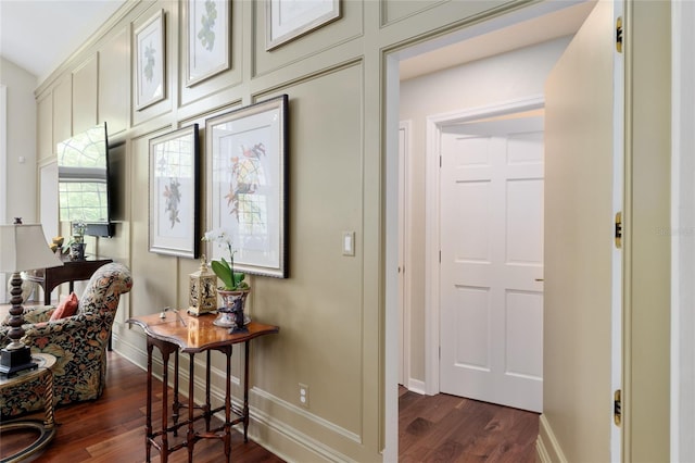 corridor featuring dark wood-style floors and baseboards