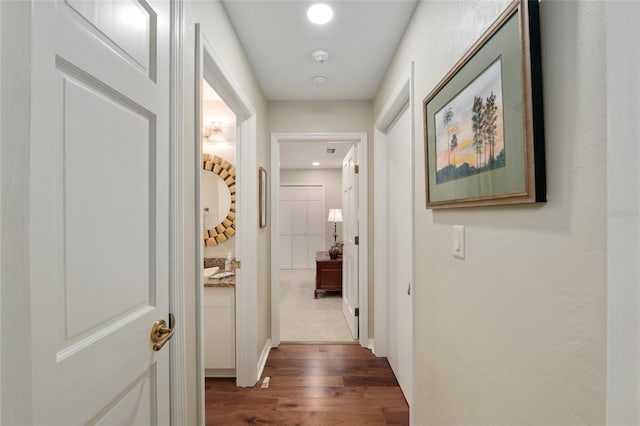 corridor featuring dark wood finished floors and recessed lighting