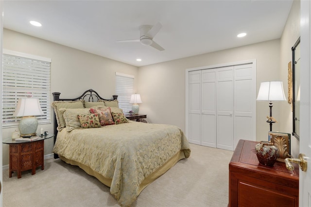 bedroom featuring recessed lighting, a closet, light colored carpet, and ceiling fan