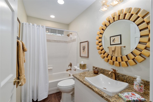 bathroom featuring shower / bath combo with shower curtain, toilet, wood finished floors, recessed lighting, and vanity