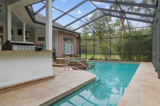 view of swimming pool featuring a pool with connected hot tub, a lanai, and a patio area