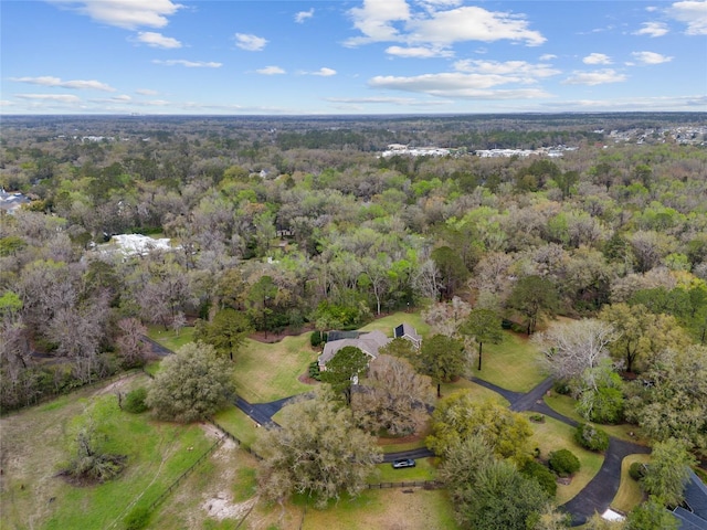 bird's eye view featuring a wooded view