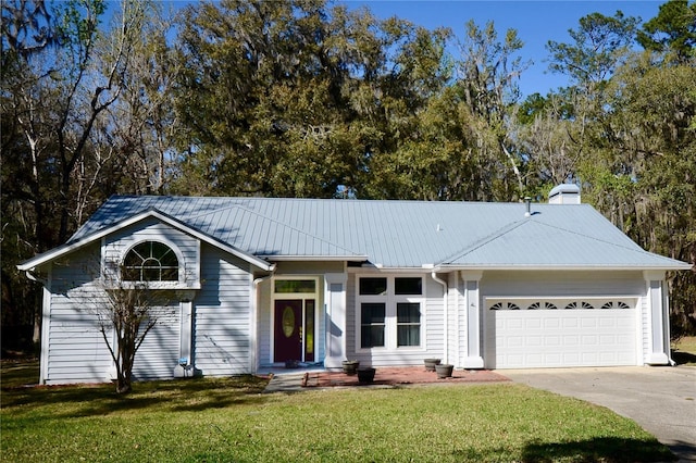 single story home featuring an attached garage, concrete driveway, a front lawn, and metal roof