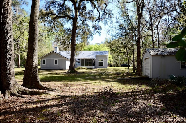 view of yard with an outbuilding and dirt driveway