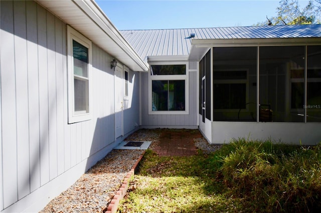 exterior space with metal roof and a sunroom