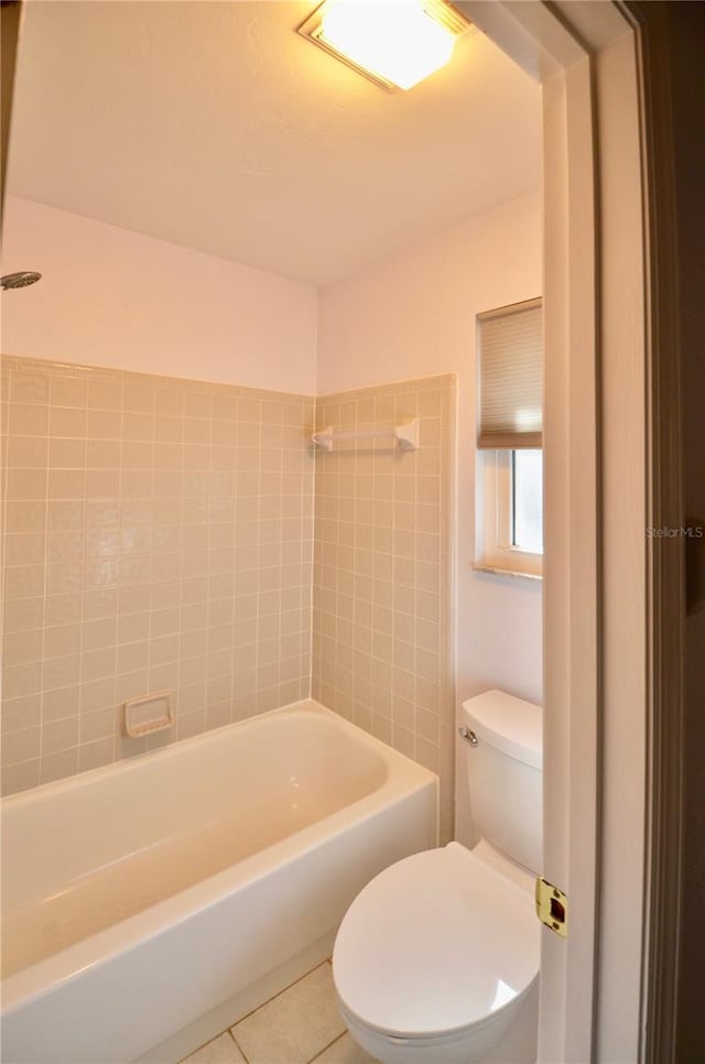 full bathroom with tile patterned floors, a bathing tub, toilet, and walk in shower