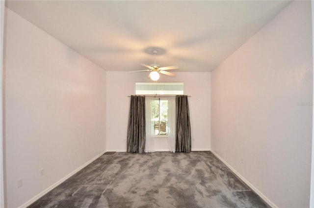 empty room featuring a ceiling fan, baseboards, and carpet floors